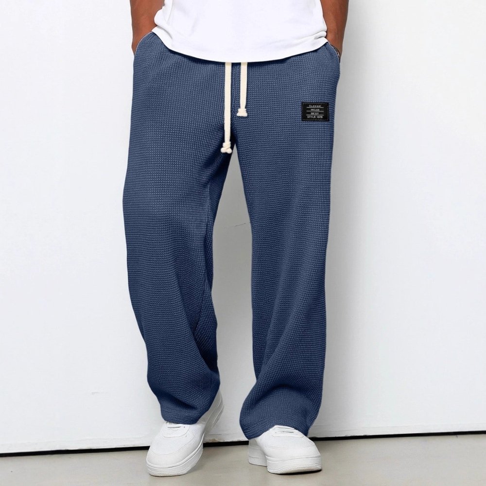 Relaxed men's waffle-texture knit pants with elastic waist, available in multiple sizes