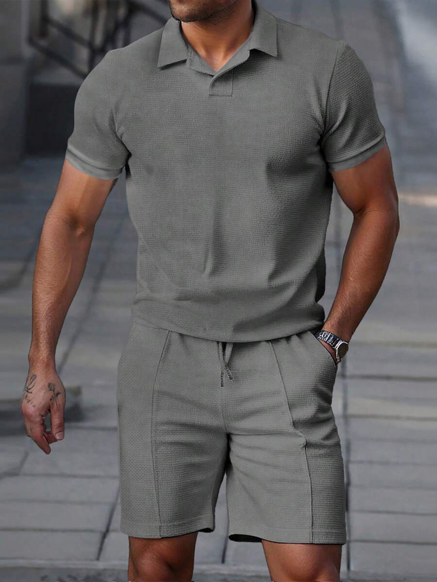 Men's textured polo and shorts set in dark grey with hip-length top and short-length coordinating shorts