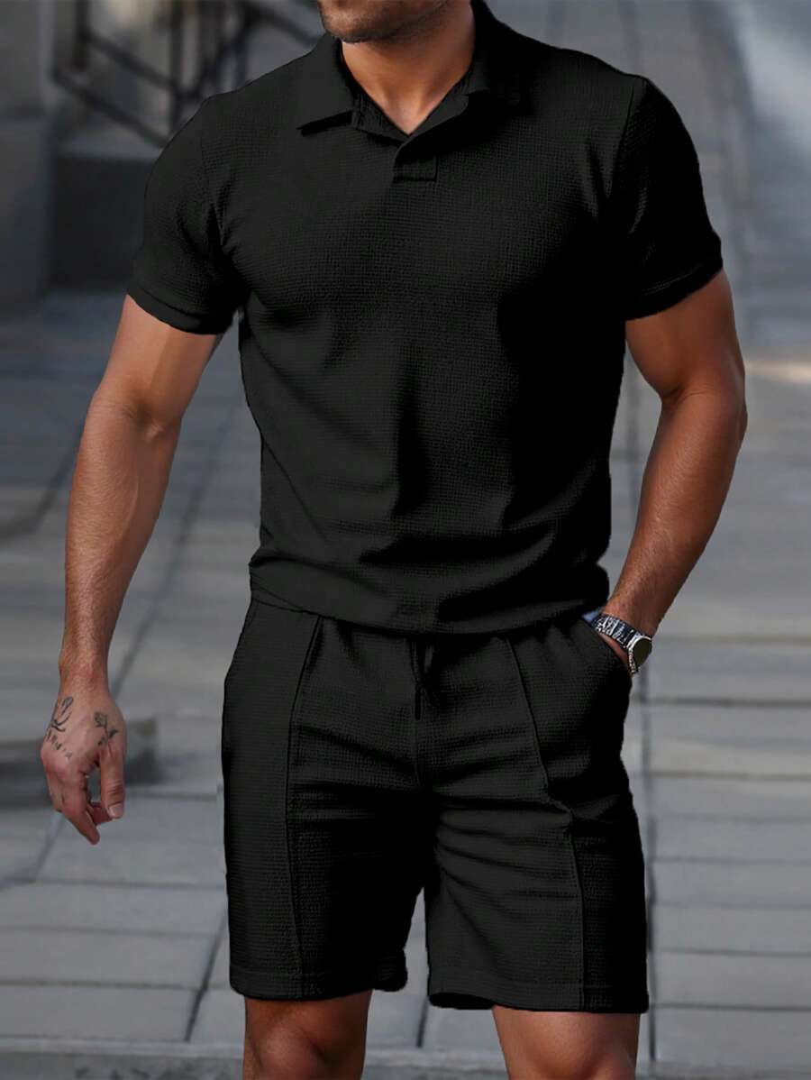 Men's textured polo shirt and shorts set in a deep black with open collar and elasticated drawstring shorts
