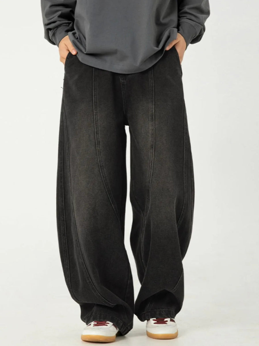 Men's relaxed-fit panel jeans in a darker denim wash with structured wide-leg silhouette