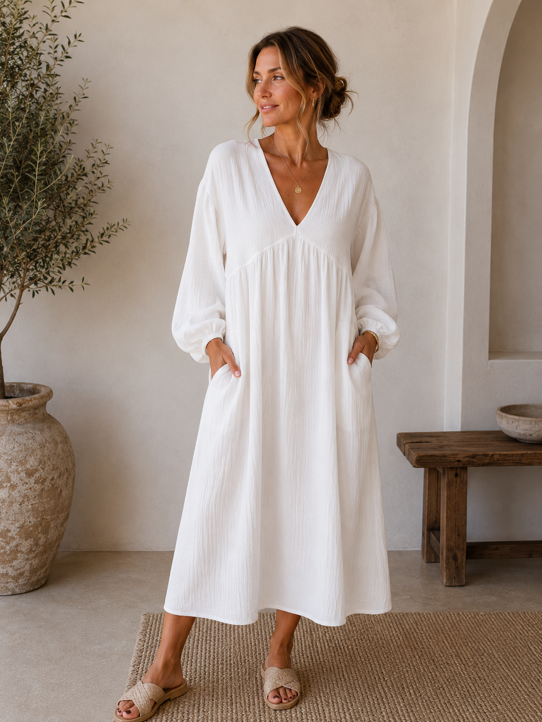 Women's loose midi dress with V-neckline, straight hem, and elastic cuffs in a spring-ready silhouette