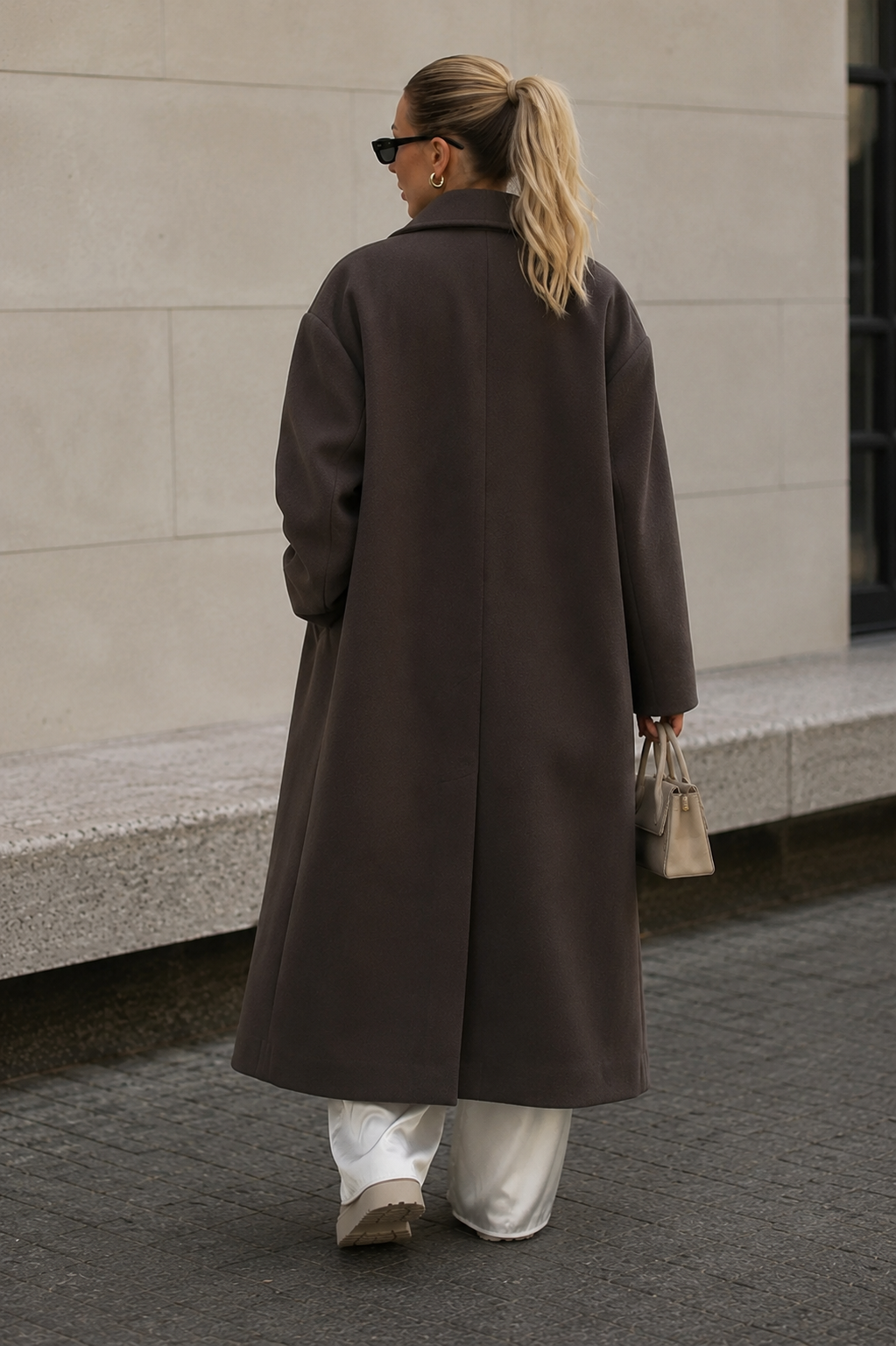 Women's long double-breasted wool blend coat, back view showing structured silhouette