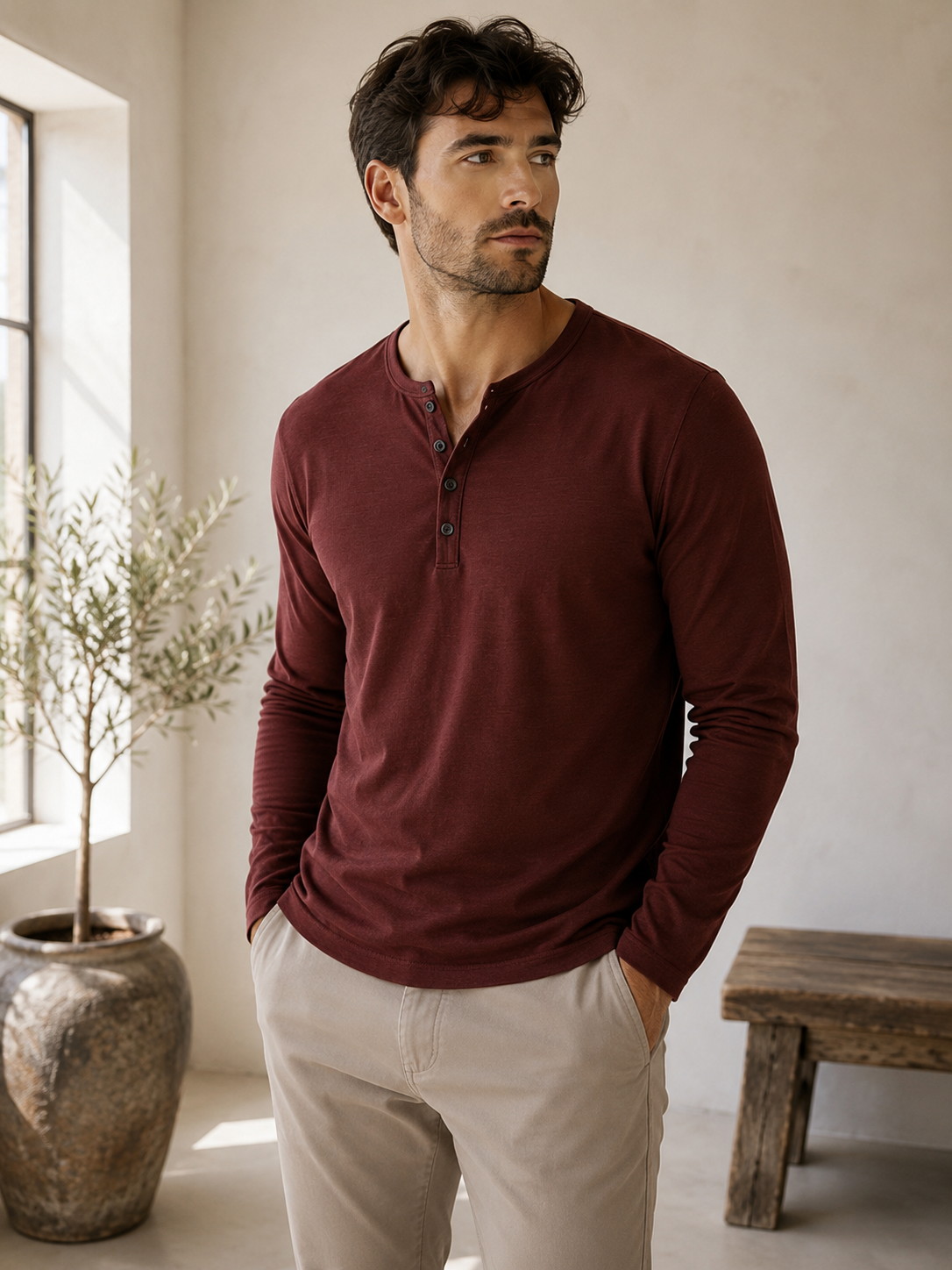 Men's Henley long-sleeved shirt laid flat, showing full length and slim fit cut