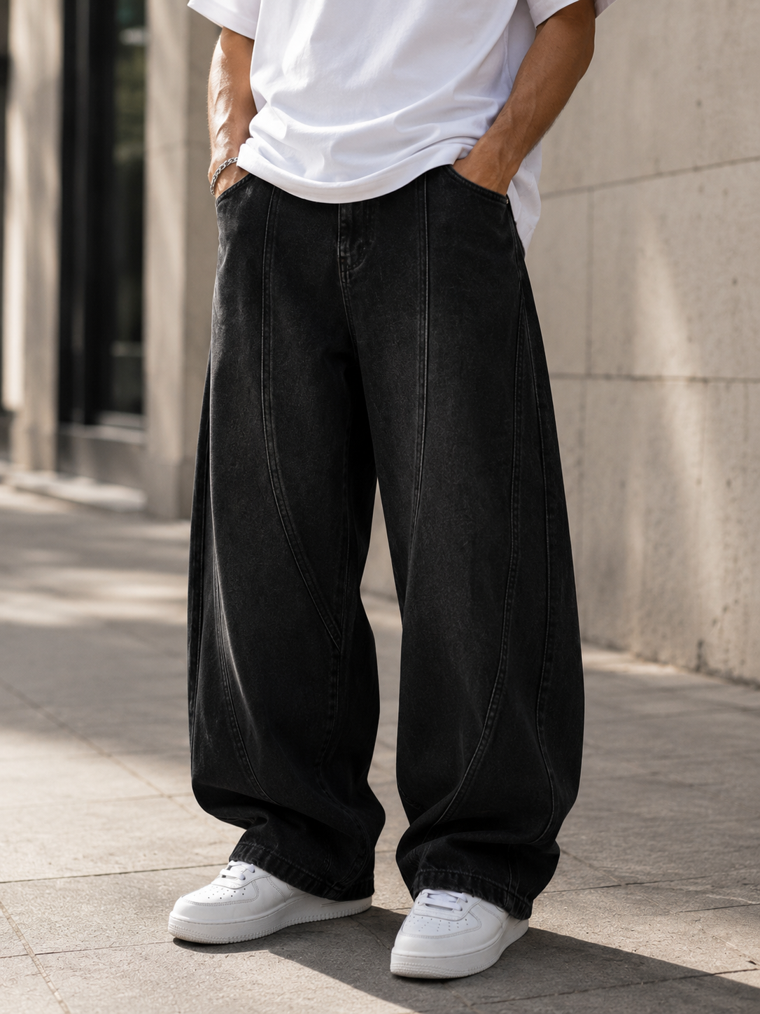 Wide-leg men's jeans featuring visible panel seams and relaxed fit through the leg