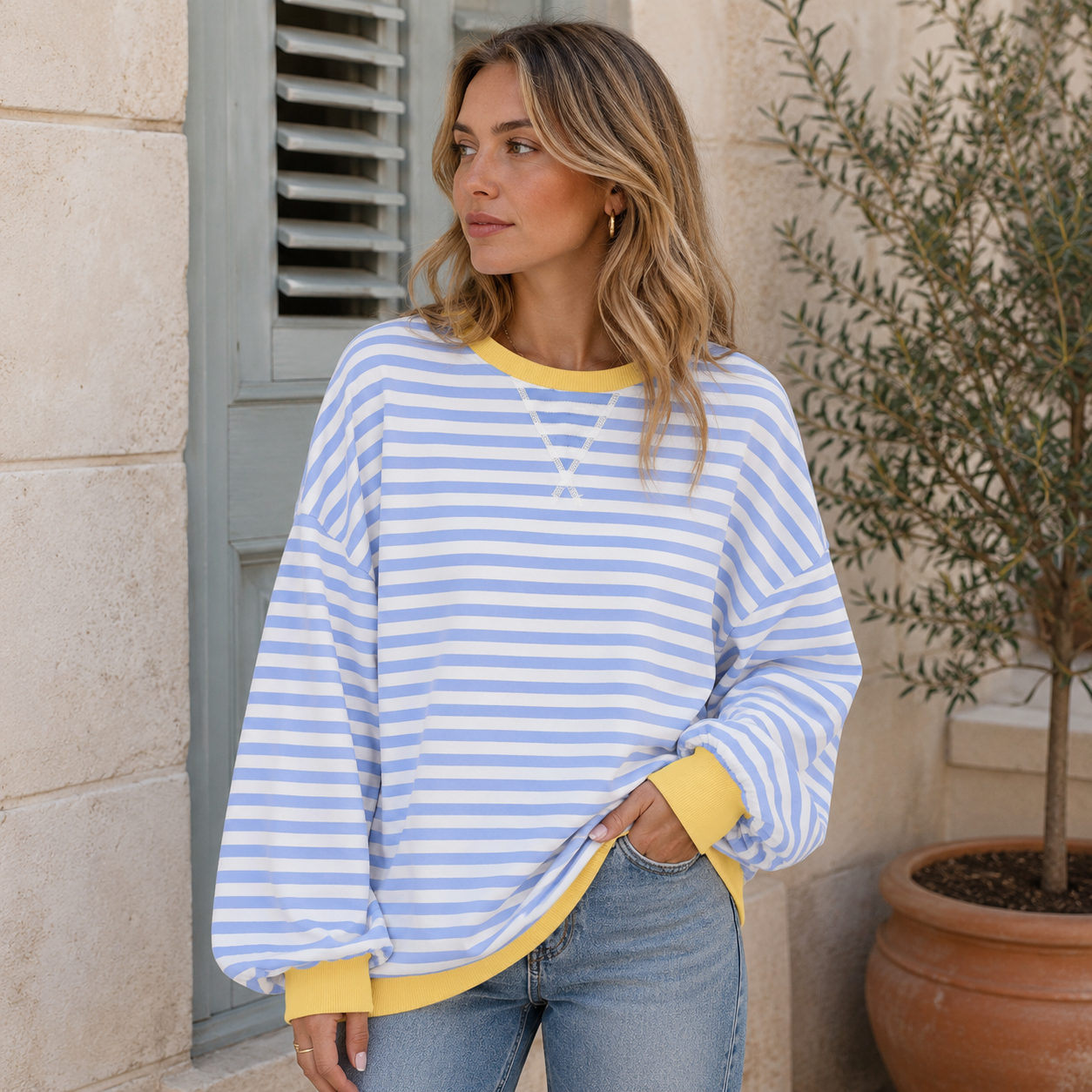 Oversized women's sweatshirt featuring a striped pattern with contrast cuffs, round neck, and relaxed fit