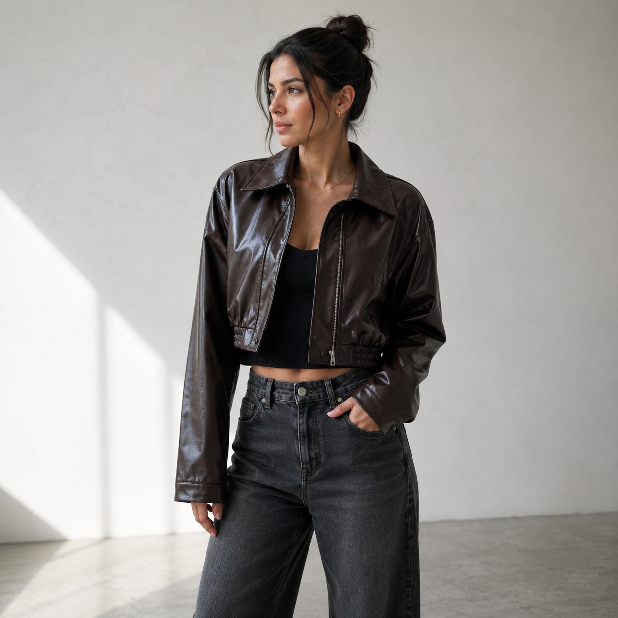 Short faux leather jacket for women with structured silhouette and smooth surface