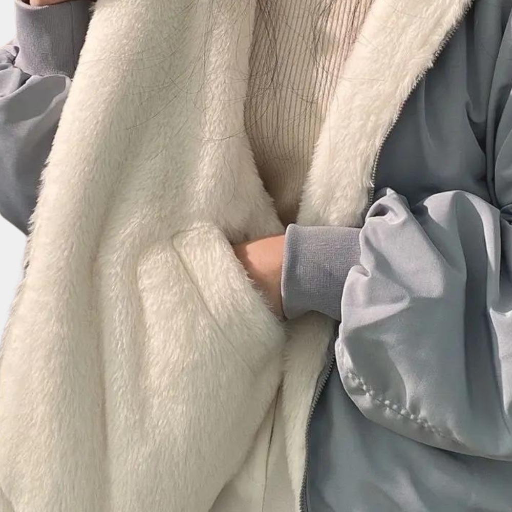 Front zipper detail on women's oversized jacket with faux fur lining, full-length view
