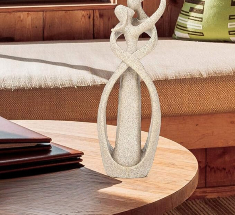 Abstract couple figurine in modern interior setting, minimalist sculpture for home decoration