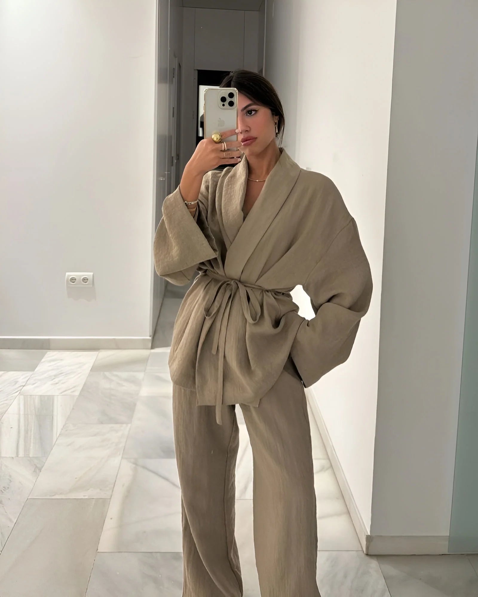 Two-piece women's set featuring a relaxed-fit wrap top and high-waist wide-leg trousers