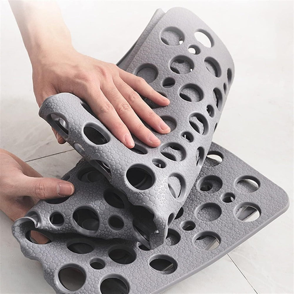 Anti-slip rubber mat with perforated design for bathroom floor placement