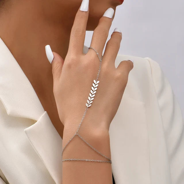 Delicate women's hand chain bracelet with finger ring, fine metal chain and adjustable wrist closure