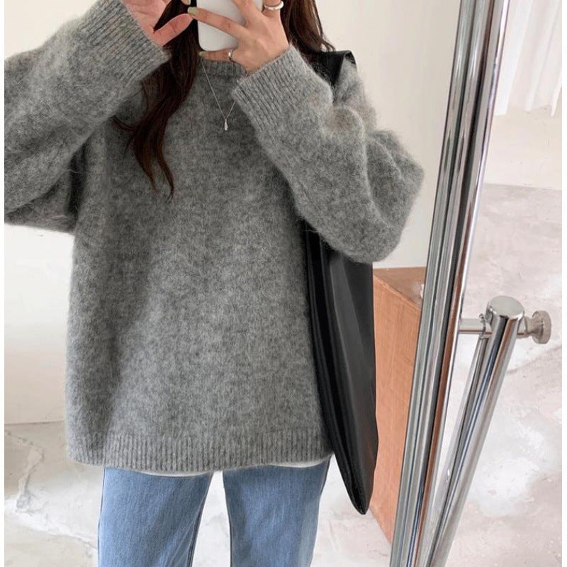 Back view of women's fuzzy knitted pullover sweater with round neckline