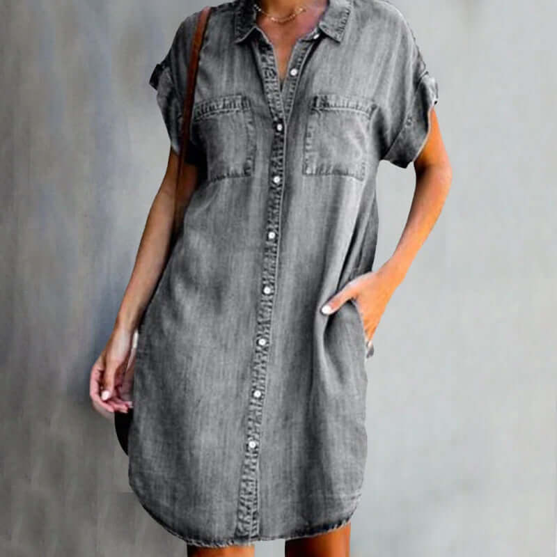 Short-sleeved denim dress for women featuring front button closure, rolled-up cuffs, and relaxed straight fit