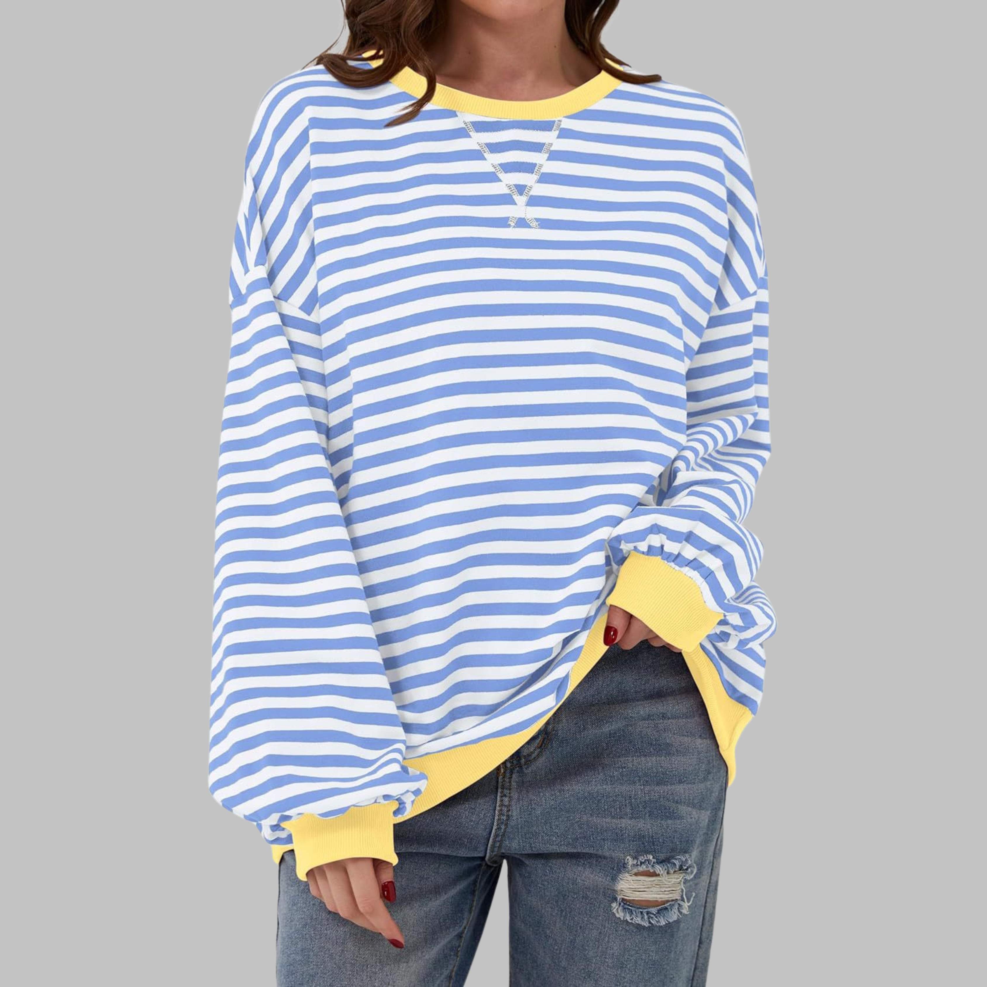 Oversized women's sweatshirt featuring a striped pattern with contrast cuffs, round neck, and relaxed fit