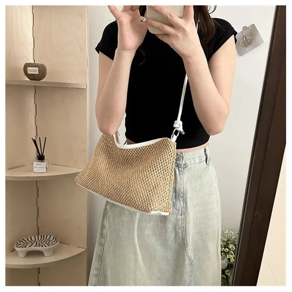 Woman carrying khaki braided shoulder bag
