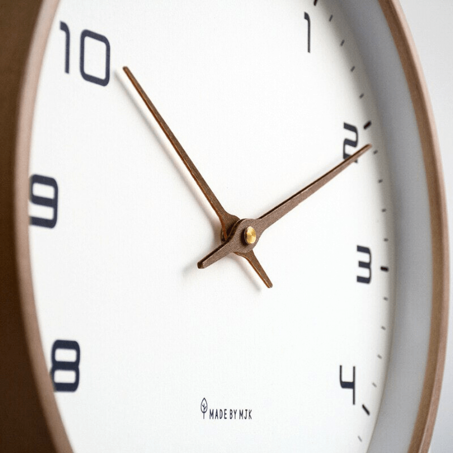 Wall clock with wooden frame styled in a Scandinavian-inspired interior space
