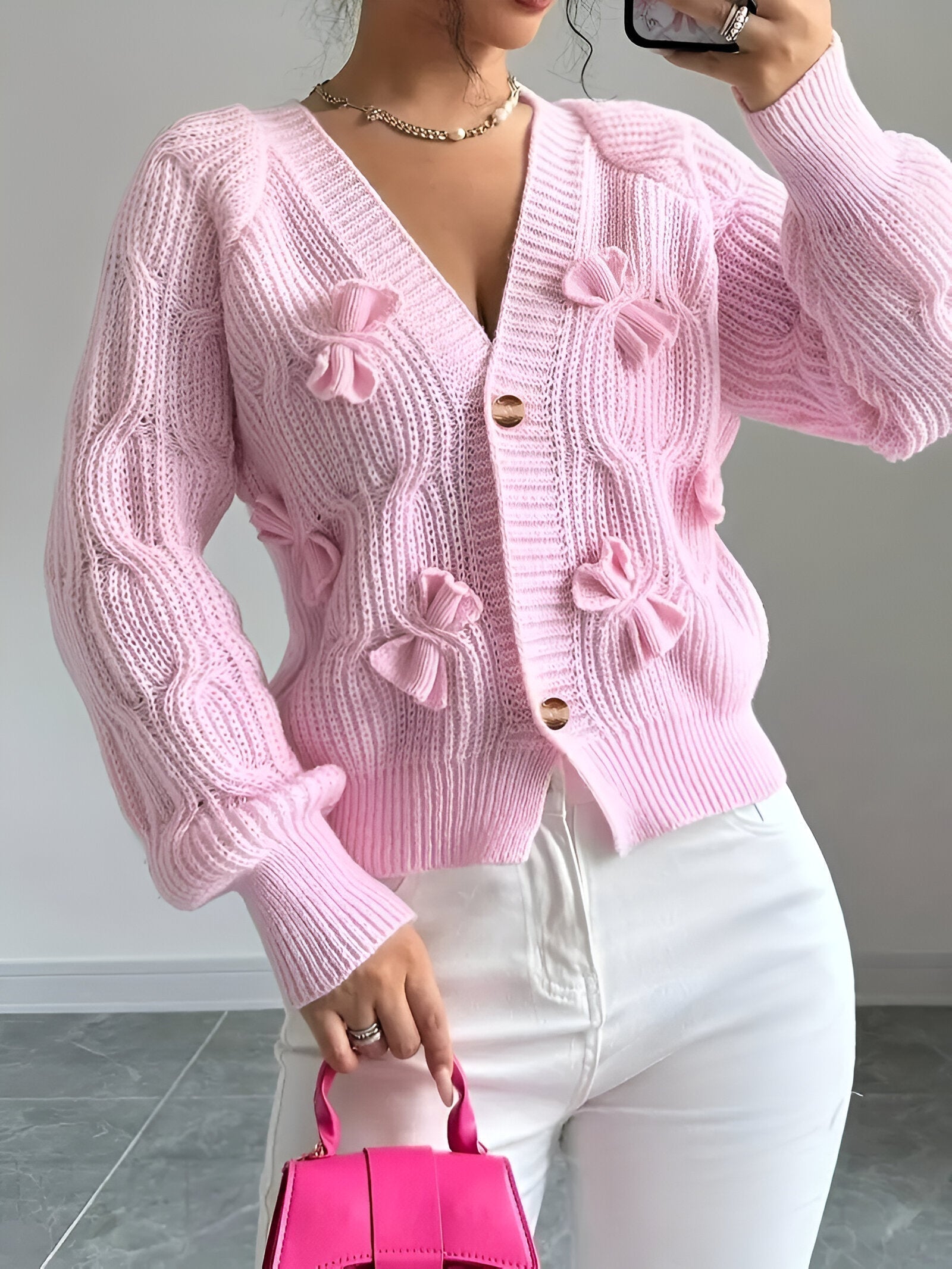 Women's knitted cardigan back view showing fitted cut and knit texture