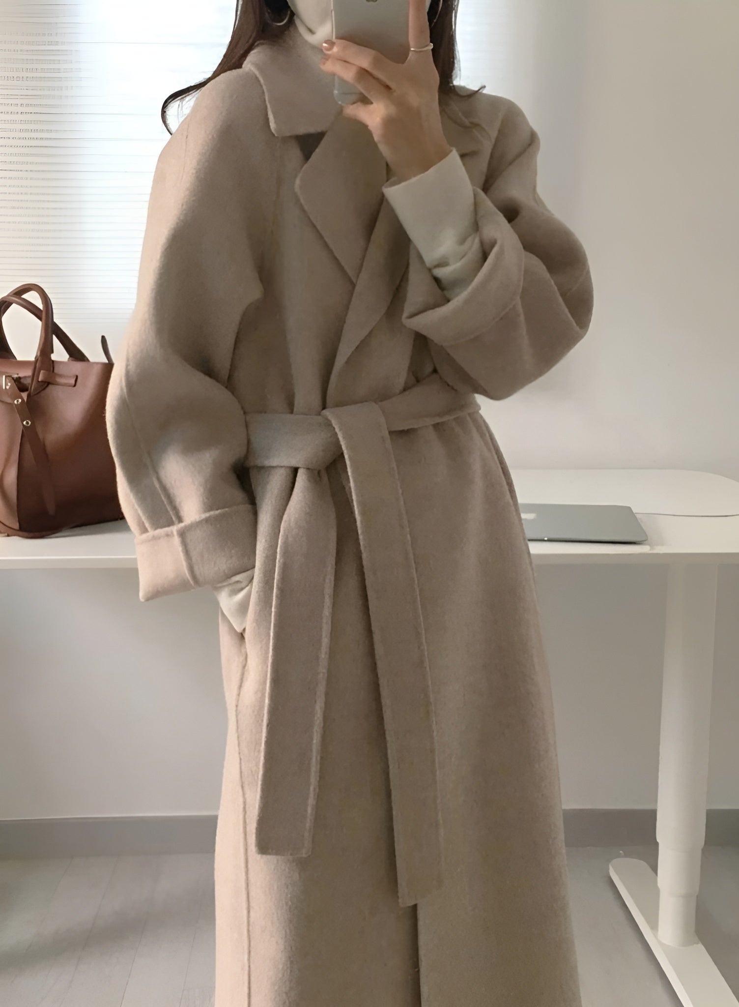 Women's long coat with belted waist and lapel collar, side view