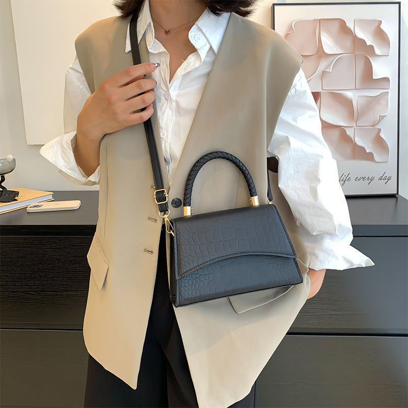 Women's faux leather handbag showing structured silhouette and side profile
