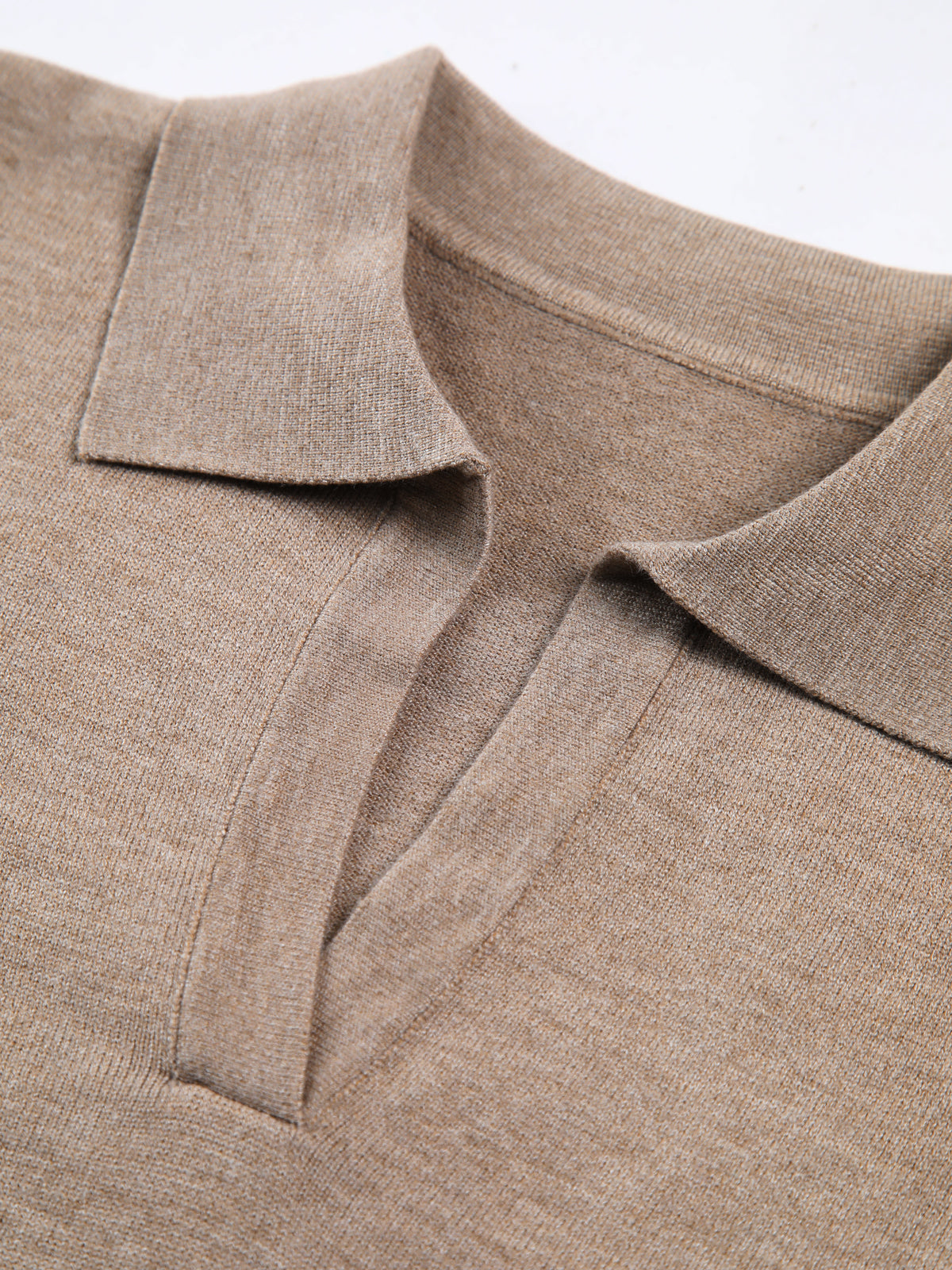 Hip-length women's knitted top with V-neck and soft collar detail