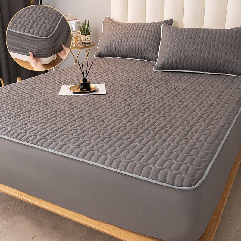 Mattress protector fitted on a bed with elastic skirt pulled taut around corners