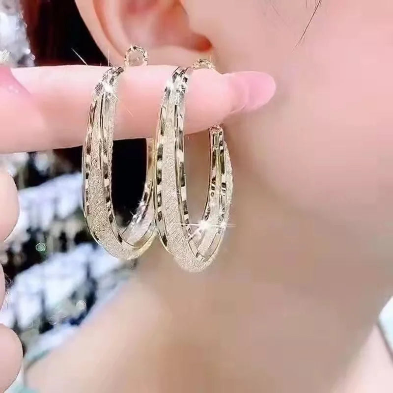 Textured metal hoop earrings with engraved detail and hinge clasp