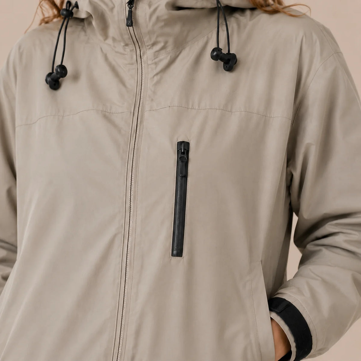 Close-up of women's Khaki raincoat zipper and hood