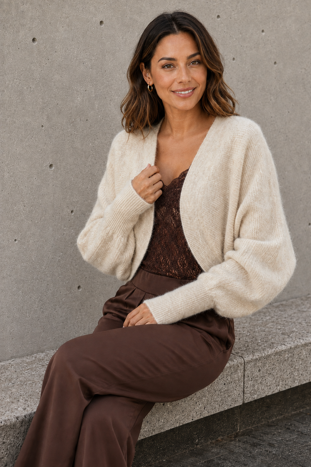 White knitted bolero for women styled with brown trousers