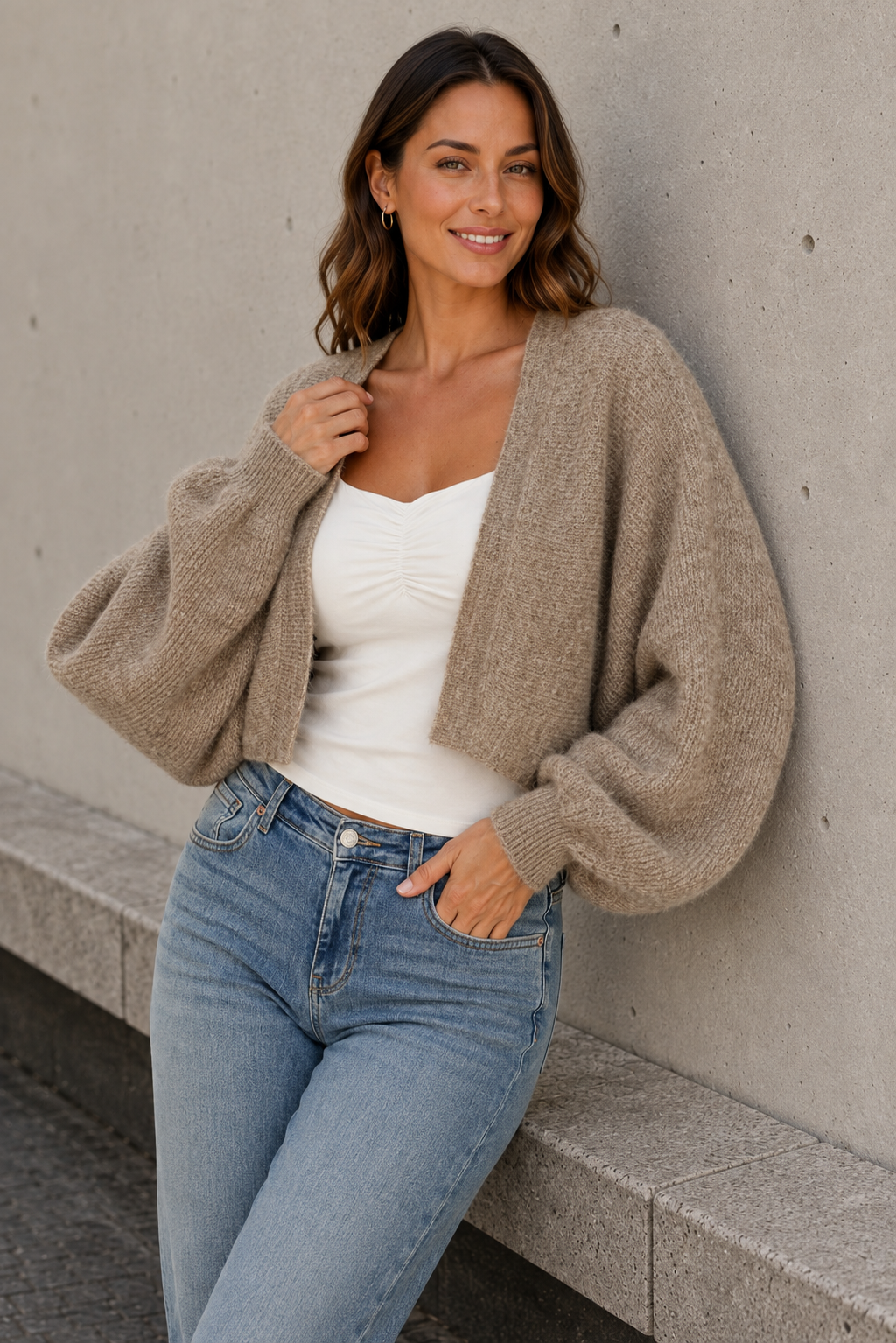 Beige knitted bolero for women with white top and jeans