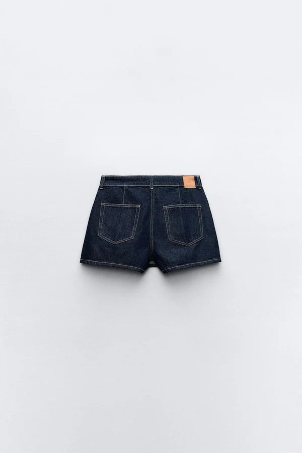Women's matching denim set with asymmetrical skirt hem and structured cropped top