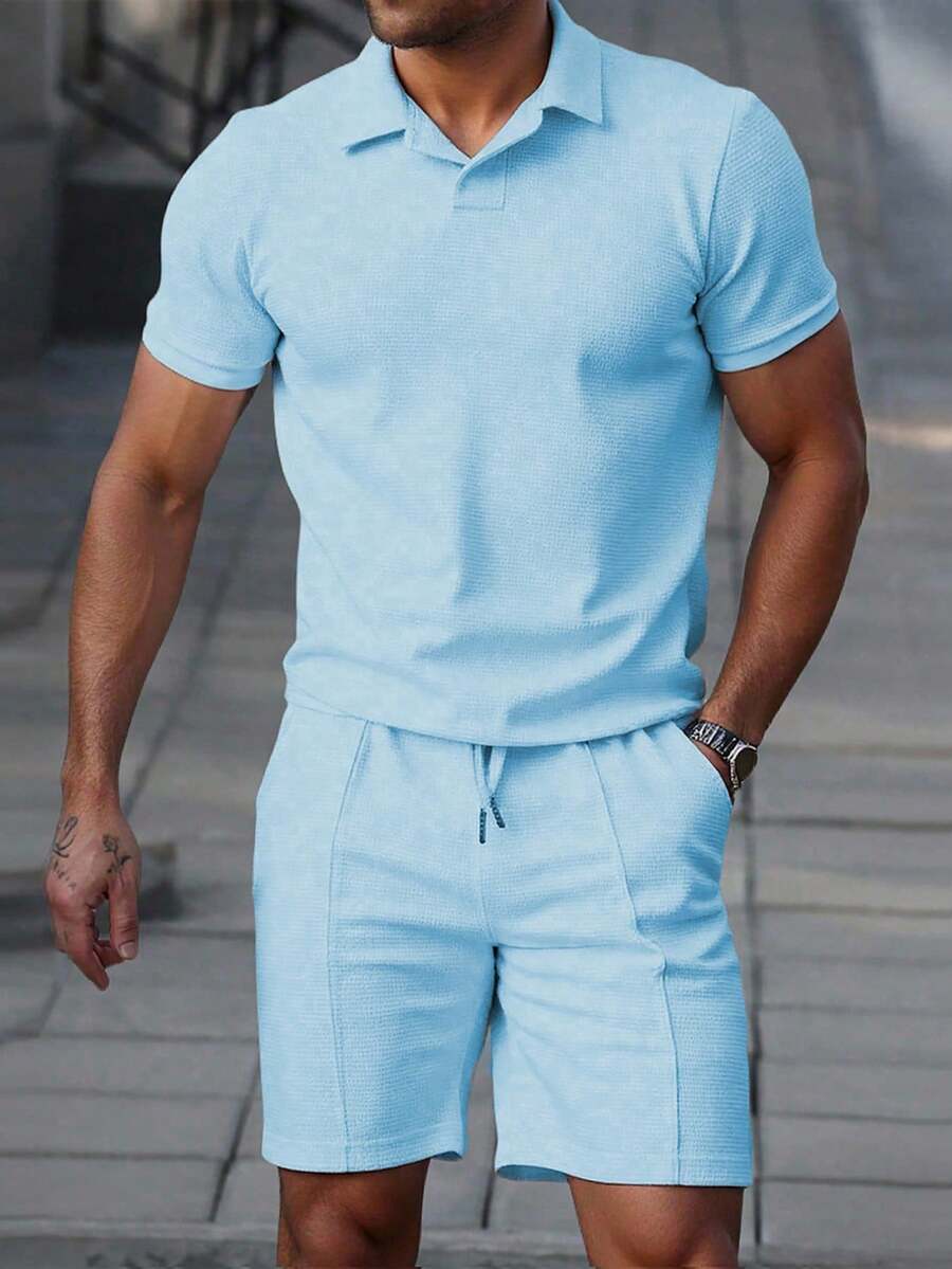 Men's textured polo shirt and shorts set in a soft baby blue with open collar and drawstring shorts
