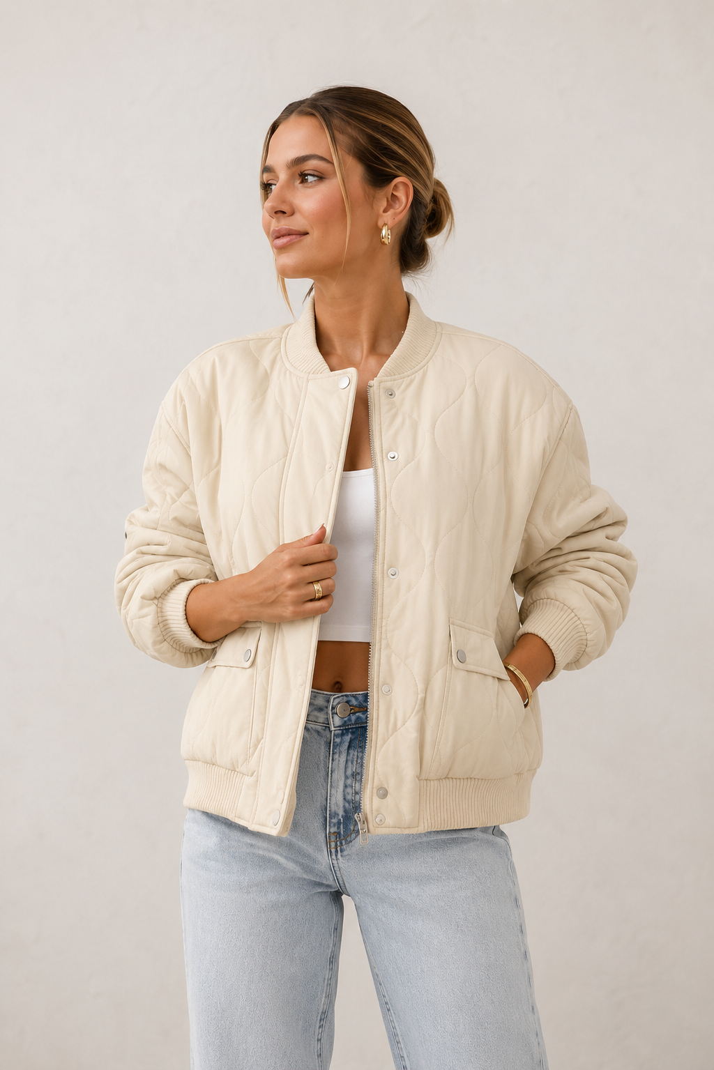 Women's padded jacket with snap button front, ribbed cuffs, and relaxed silhouette