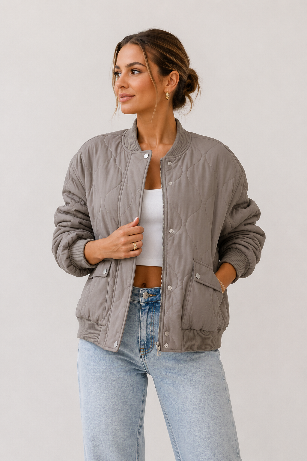 Padded women's jacket with round neckline, long sleeves, and snap button front