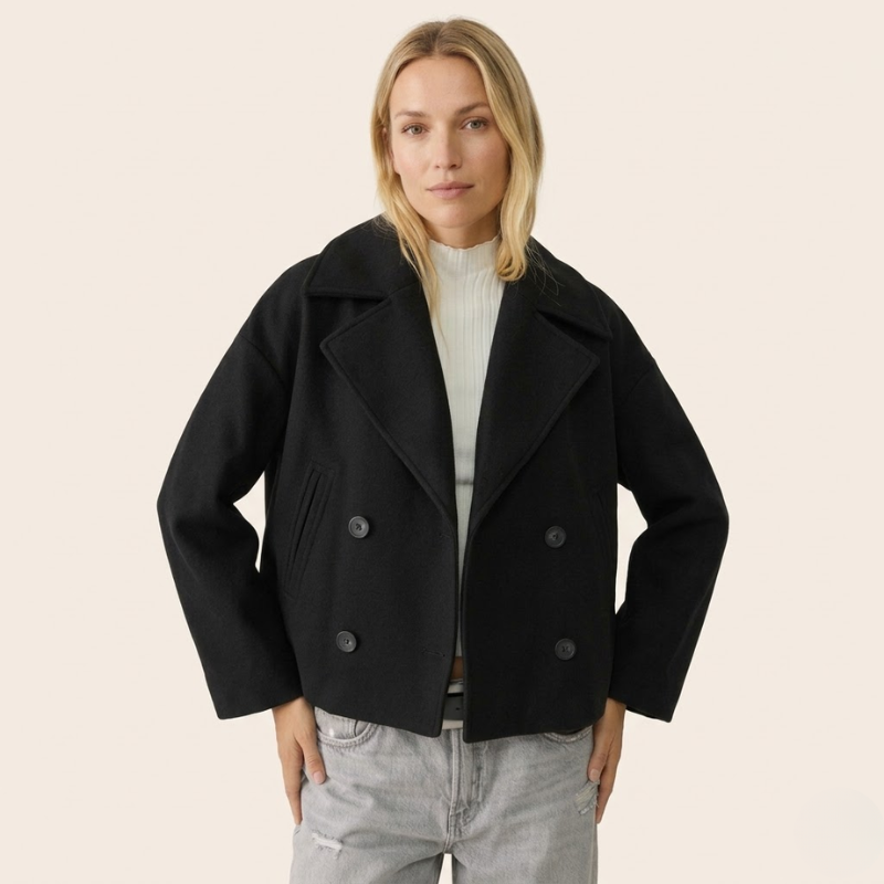 Short double-breasted women's coat with long sleeves and smooth panel construction