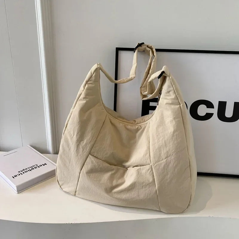 Lightweight padded shoulder bag laid flat on surface