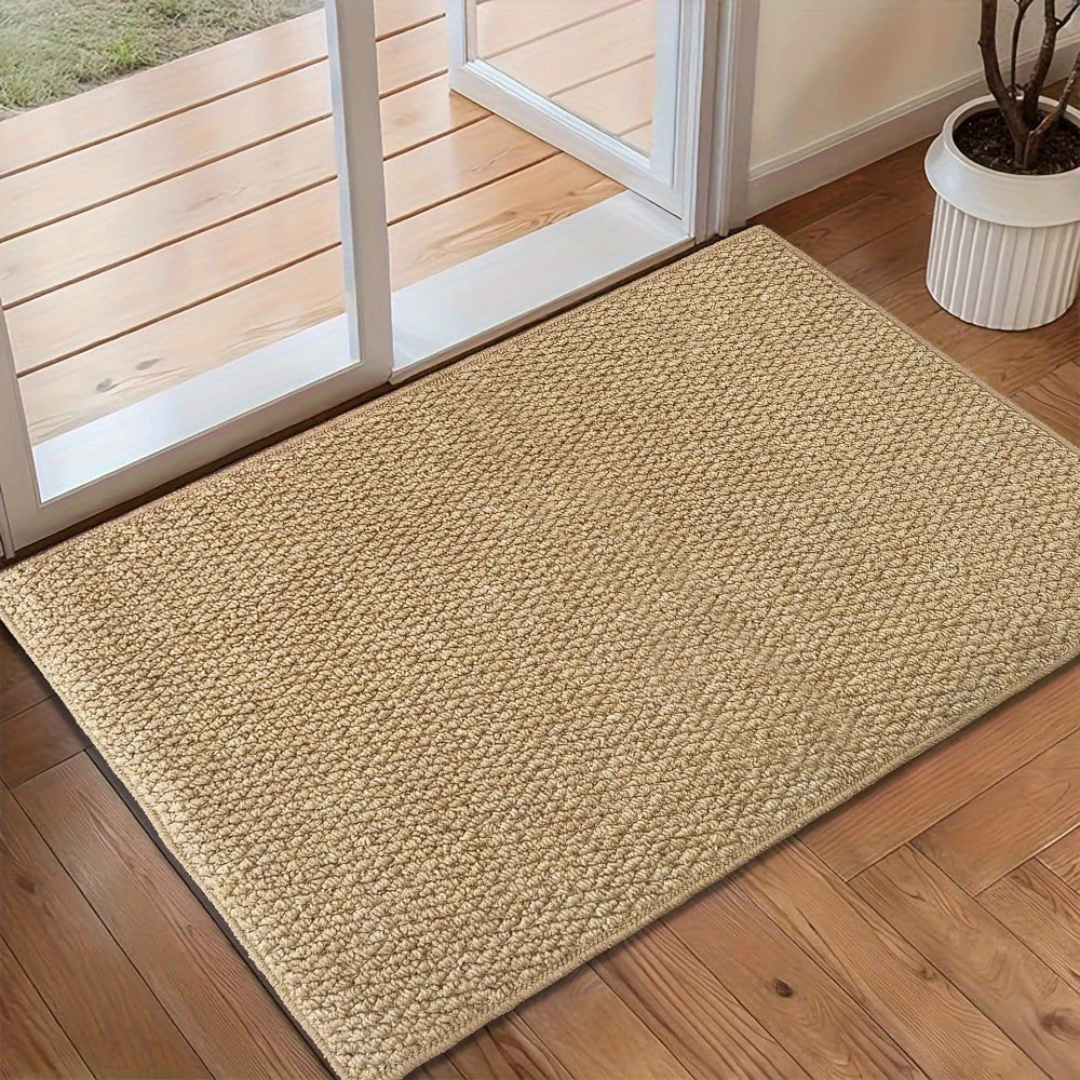Indoor woven entrance mat with low-profile rectangular silhouette and compact weave construction