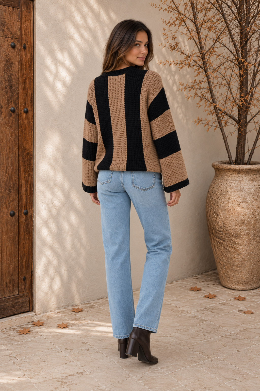 Women's camel and black striped chunky-knit sweater with dropped shoulders and ribbed hem, back view