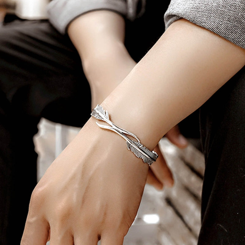 Adjustable feather bracelet worn on wrist, lifestyle shot