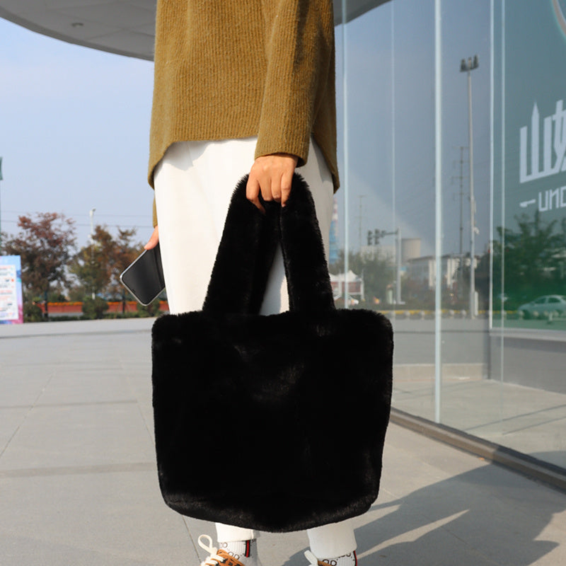 Women's faux fur tote bag displayed at an angle, highlighting spacious main compartment