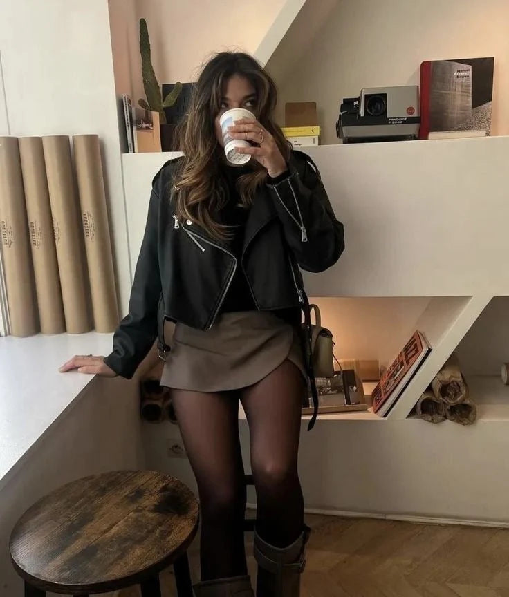 Women’s brown high waist skort styled with black jacket and boots