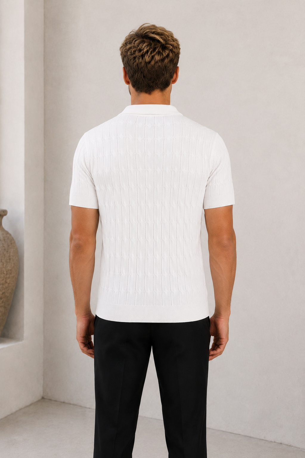 Man wearing white textured short sleeve polo shirt