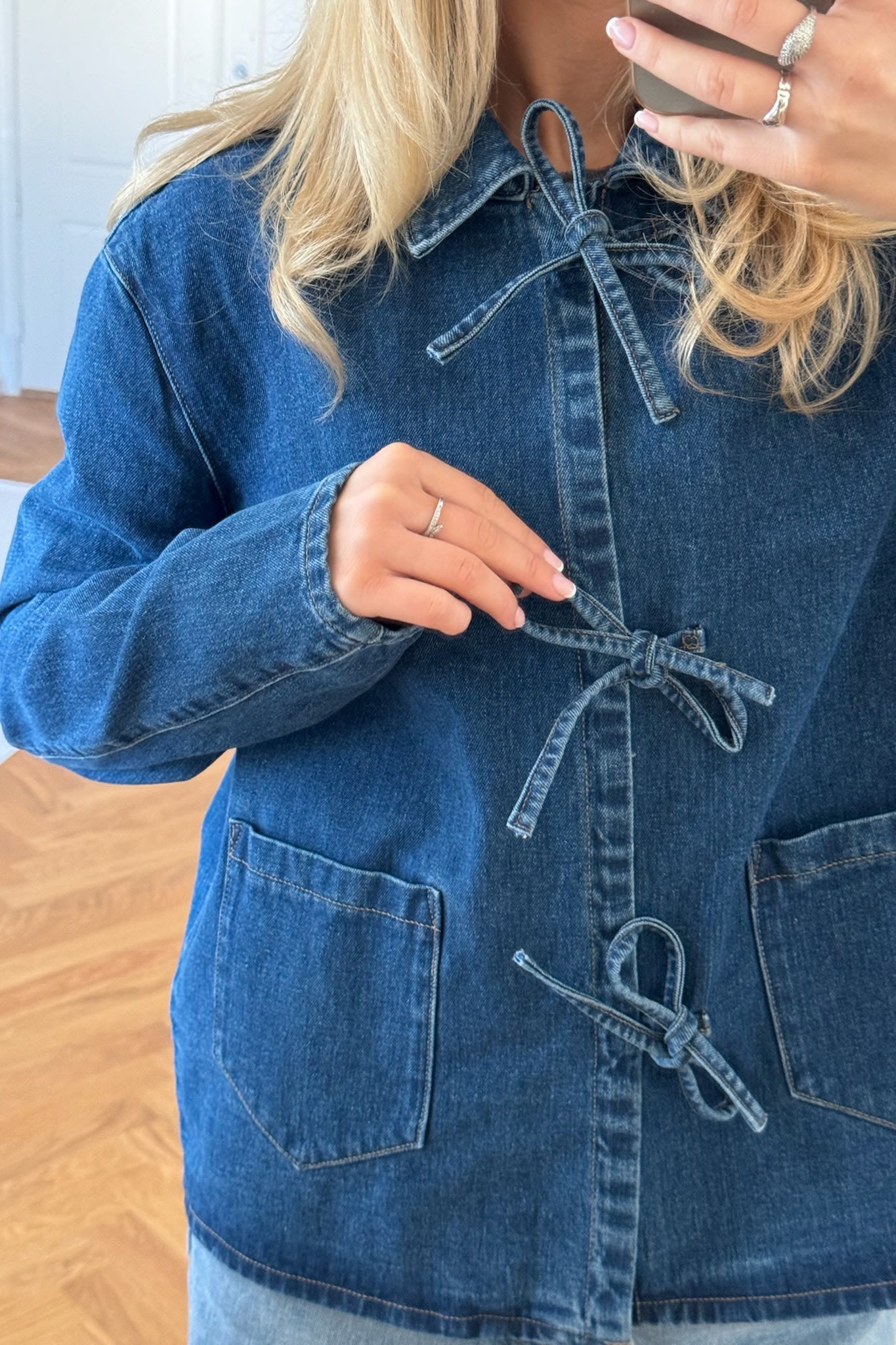 Women's hip-length denim jacket with patch pockets and washed finish
