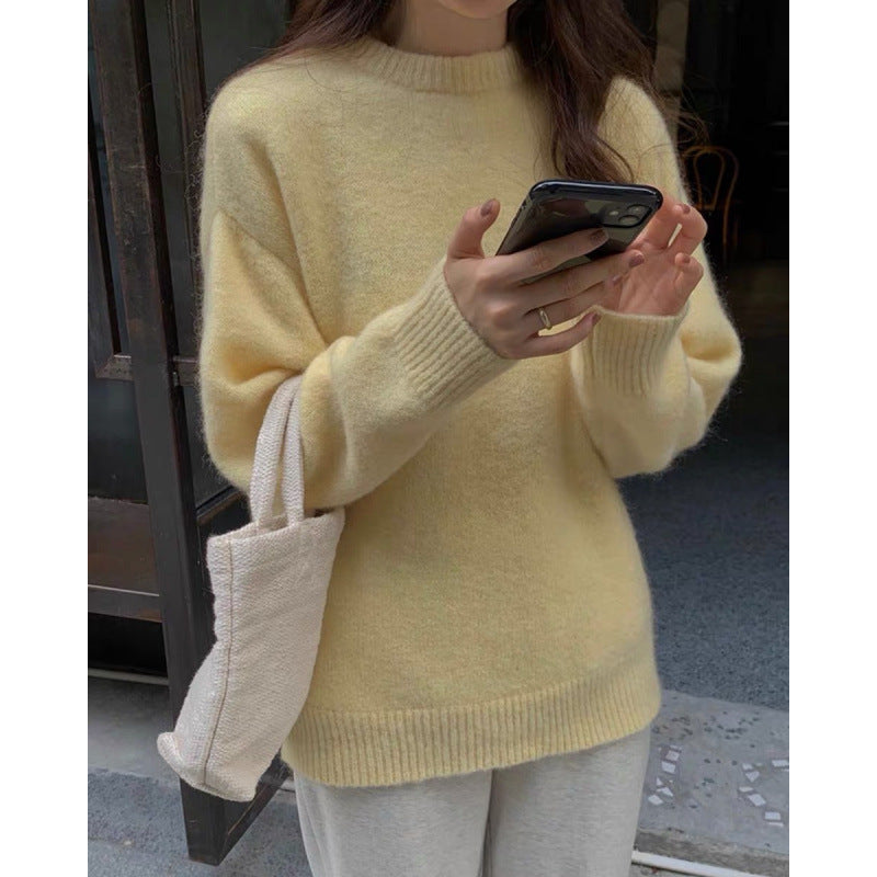 Women's fuzzy knitted sweater showing sleeve length and relaxed body fit
