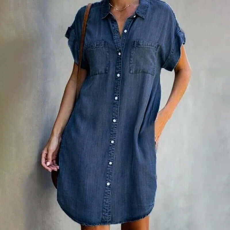 Women's knee-length denim shirt dress with classic collar, side pockets, and short rolled-up sleeves