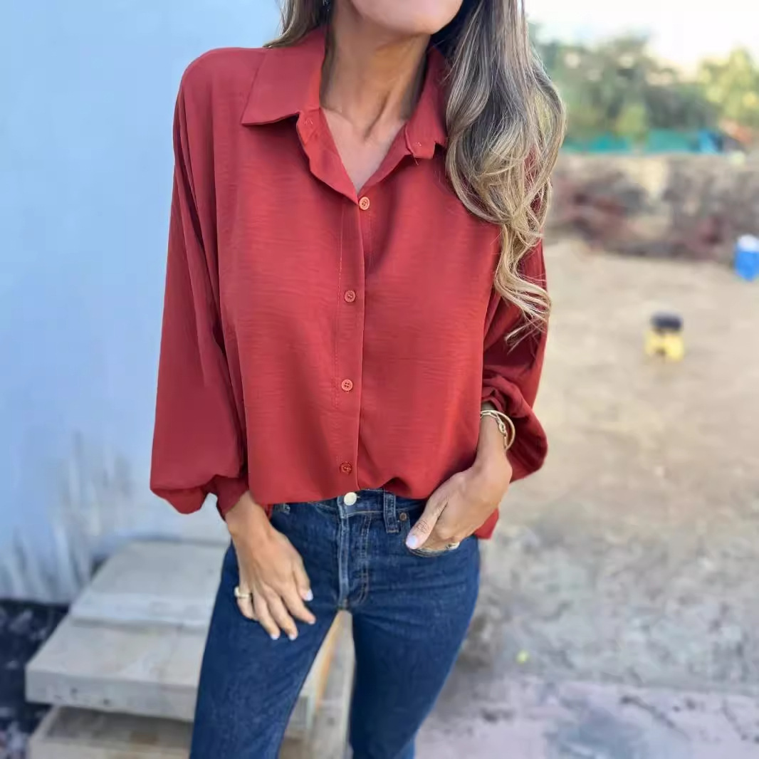 Women's relaxed blouse with button closure, shirt collar, and 3/4-length sleeves for a polished look