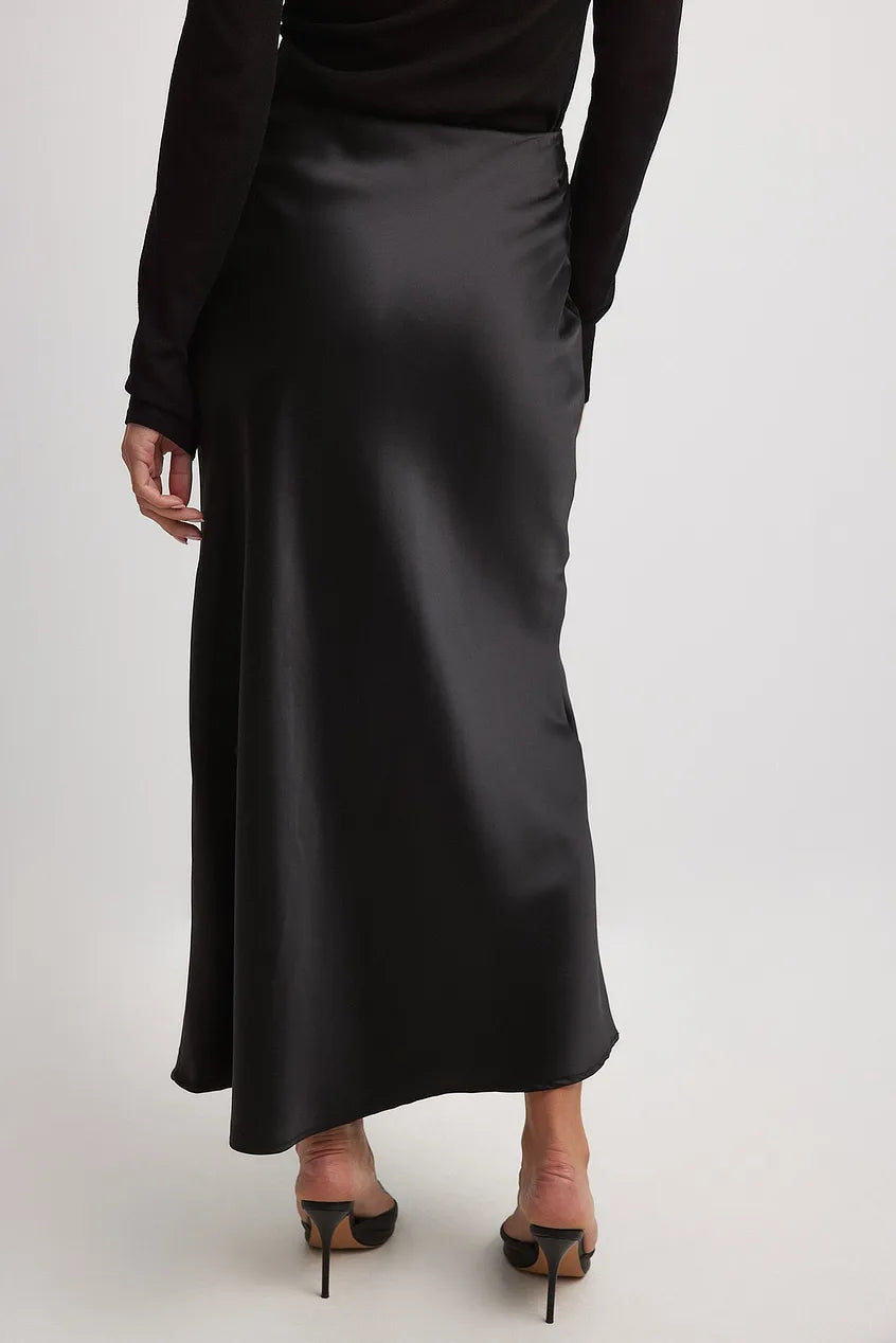 Full-length view of women's satin midi skirt with straight cut and elastic waistband