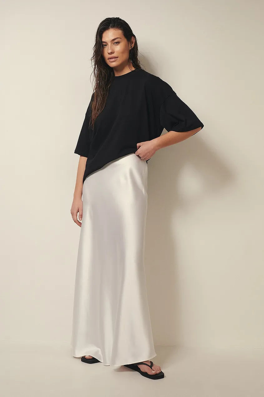Women's satin midi skirt in motion showing fluid fabric and midi hemline