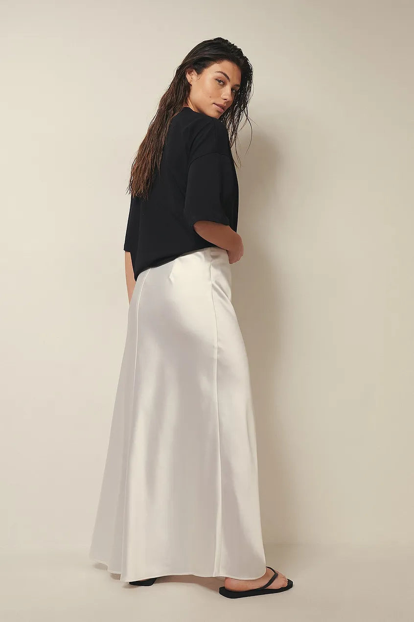 Close-up of satin midi skirt fabric showing smooth surface and subtle luster