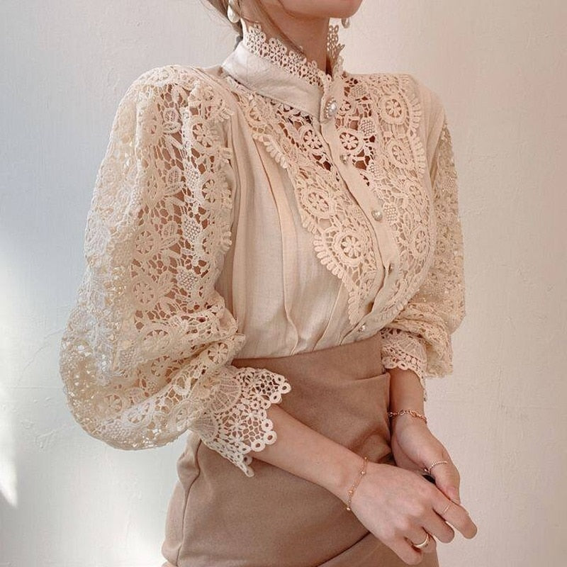 Close-up of lace fabric texture on a women's long-sleeve blouse with high collar