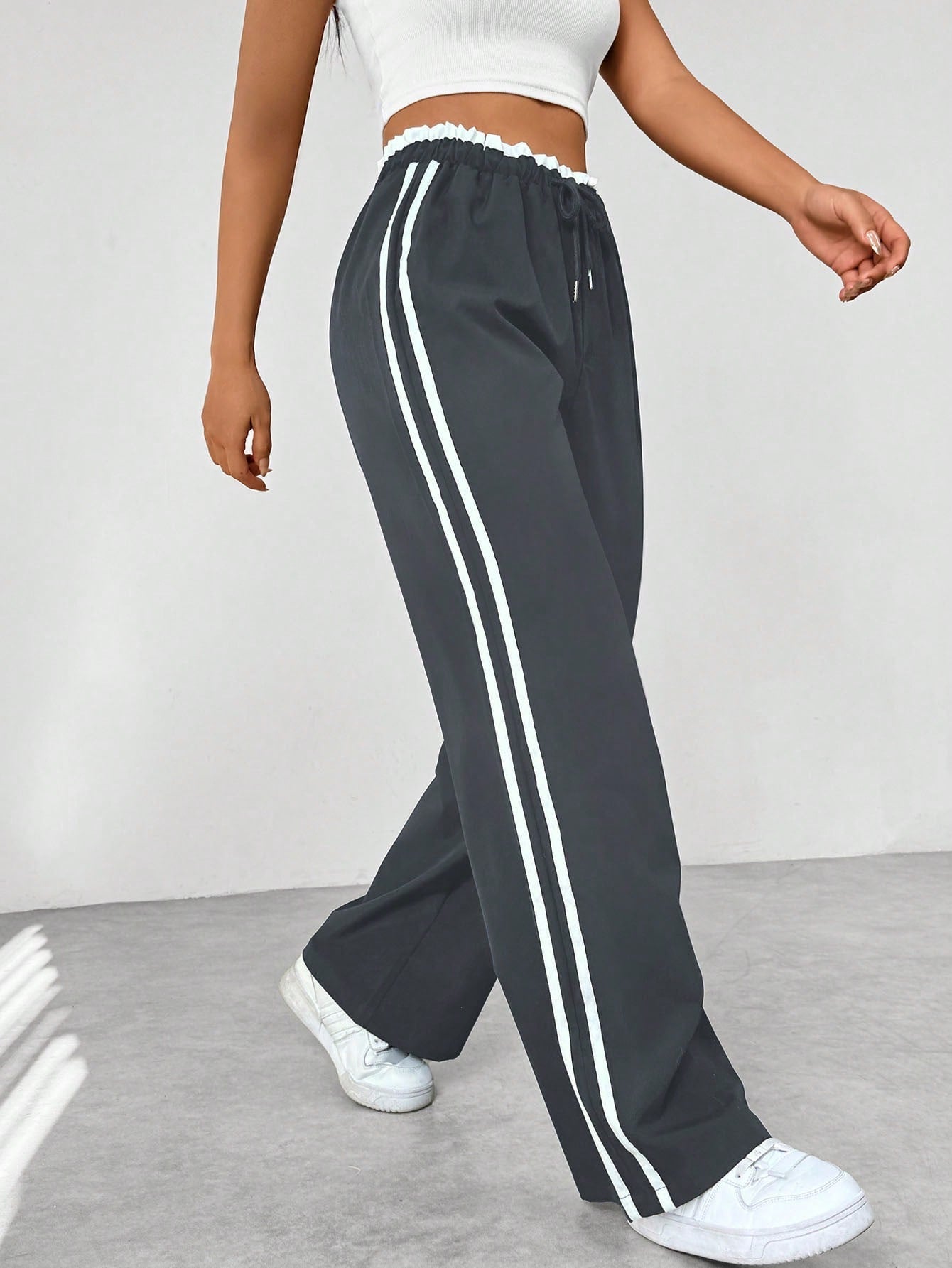 Close-up of elastic drawstring waistband on women's wide-leg sweatpants